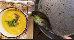 Transfer mustard seeds and curry leaves to ash gourd